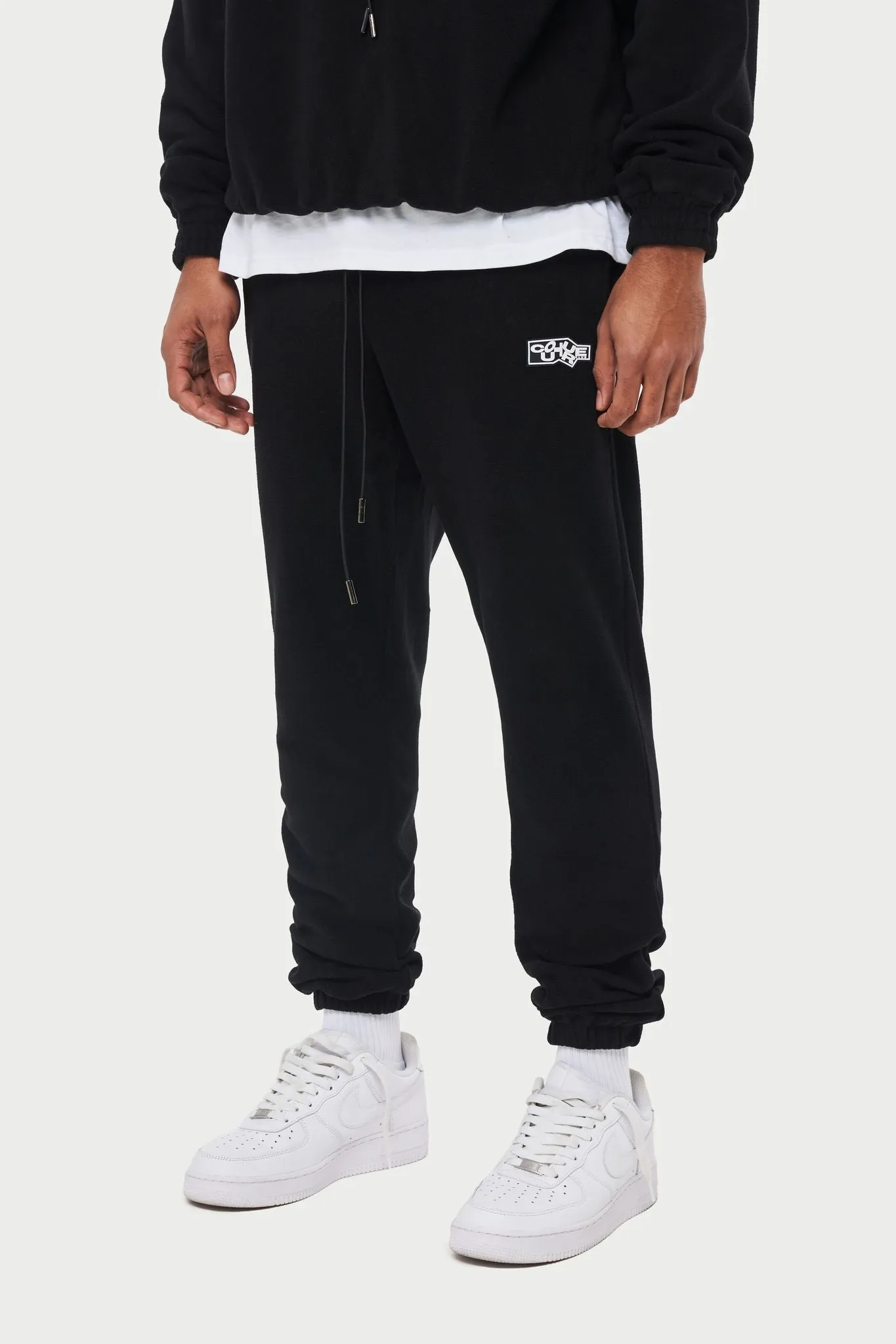 POLAR FLEECE RUBBER BADGE TRACKSUIT JOGGERS - BLACK