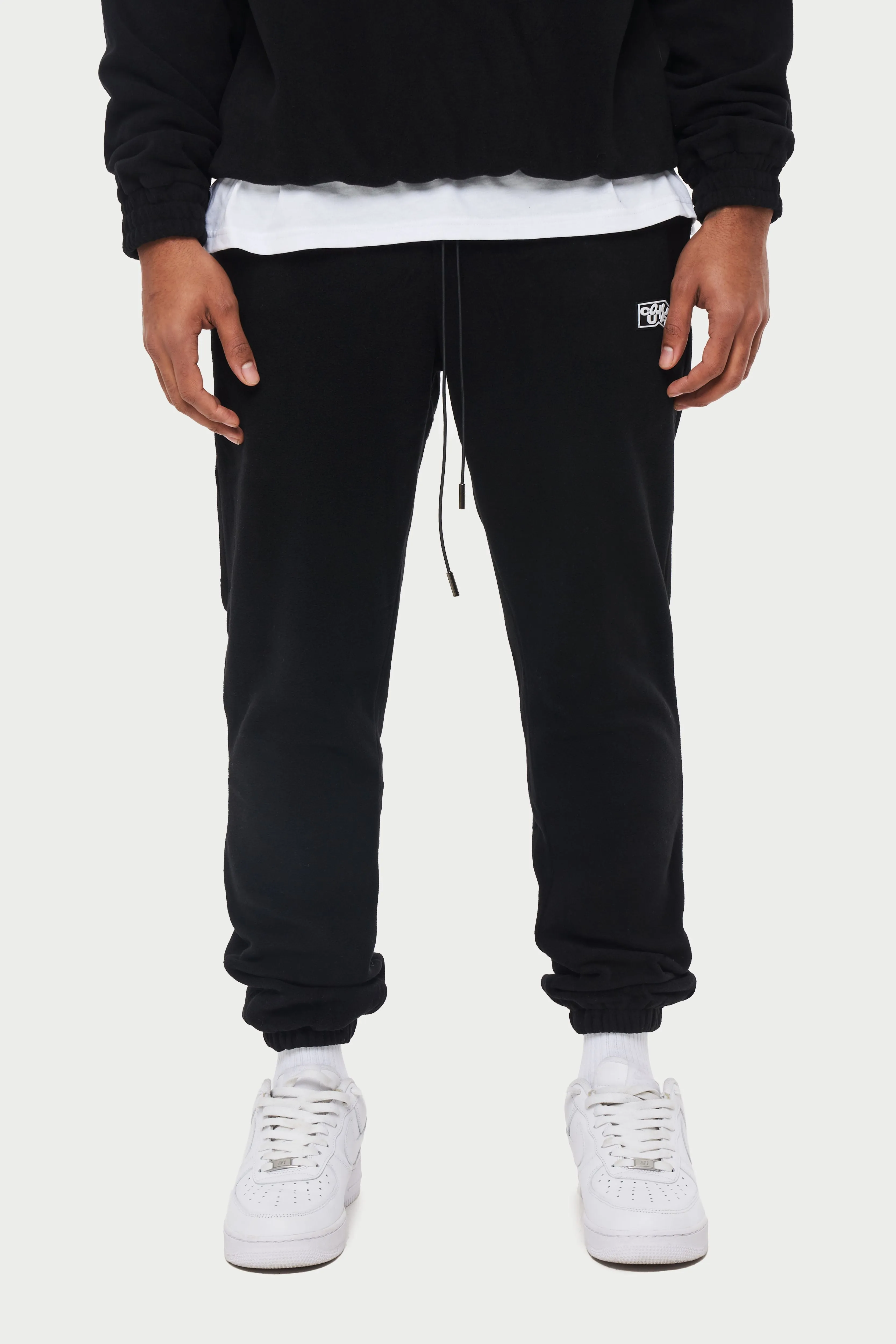 POLAR FLEECE RUBBER BADGE TRACKSUIT JOGGERS - BLACK